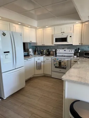 a kitchen with a stove a sink and a refrigerator