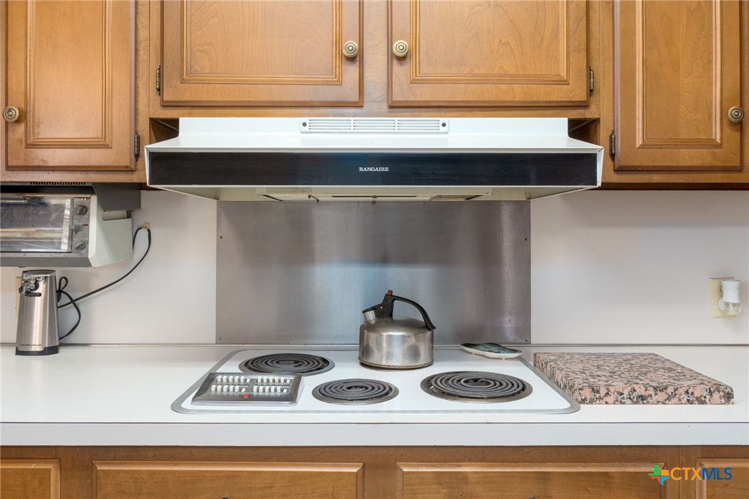 1003 North Ridge Street Lampasas, TX 76550 - Photo 12 of 44 a kitchen with a stove and a cabinets