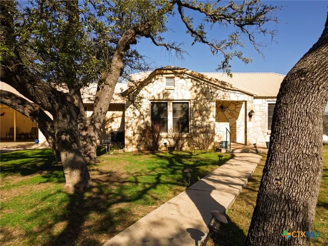a living room with furniture a flat screen tv and a window