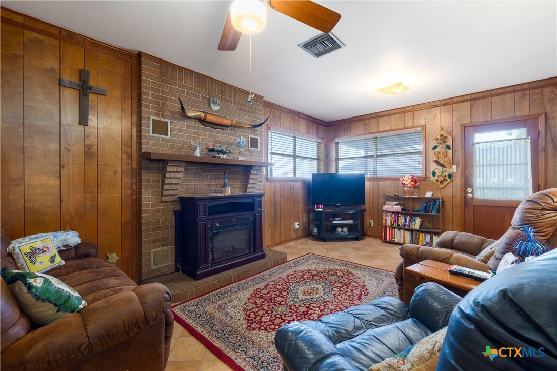 1003 North Ridge Street Lampasas, TX 76550 - Photo 8 of 44 a living room with furniture a fireplace and a flat screen tv