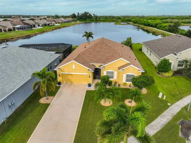 an aerial view of residential houses with outdoor space and lake view