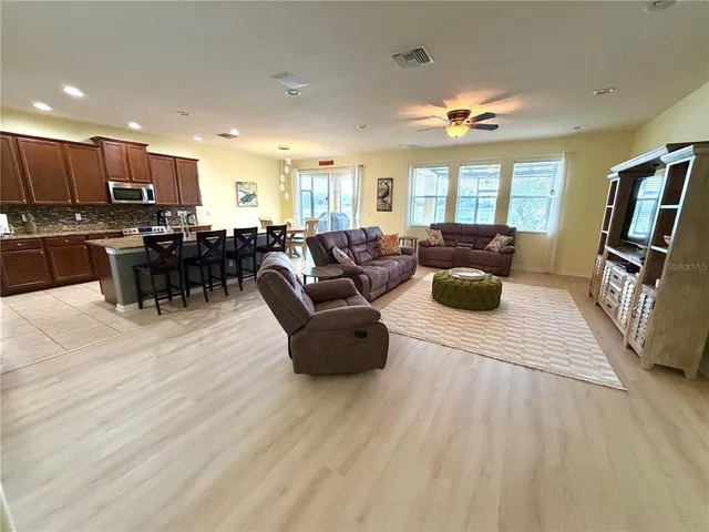 a large kitchen with granite countertop a sink and a refrigerator
