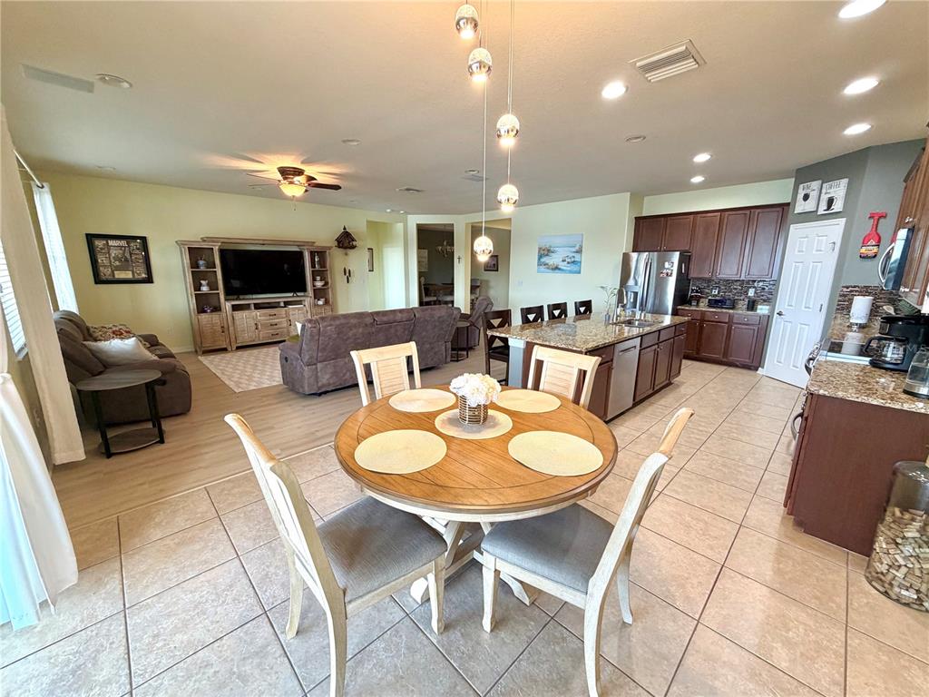 1516 Yale Castle Court Ruskin, FL 33570 - Photo 15 of 52 a living room with furniture a flat screen tv and kitchen view