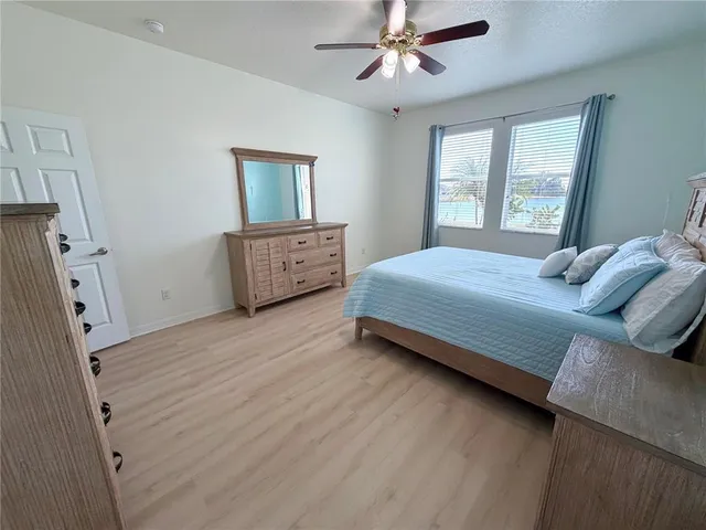 a bedroom with a bed dresser and a window