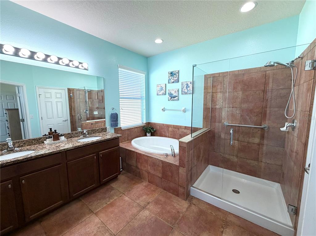 1516 Yale Castle Court Ruskin, FL 33570 - Photo 30 of 52 a bathroom with a tub a sink and glass door