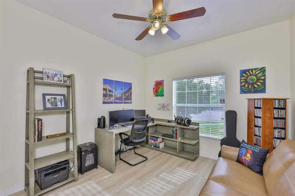1516 Yale Castle Court Ruskin, FL 33570 - Photo 34 of 52 a living room with furniture a bookshelf and a window