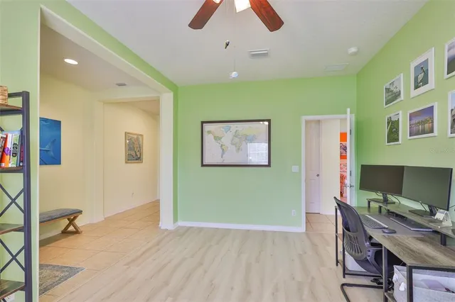 a workspace room with furniture and wooden floor