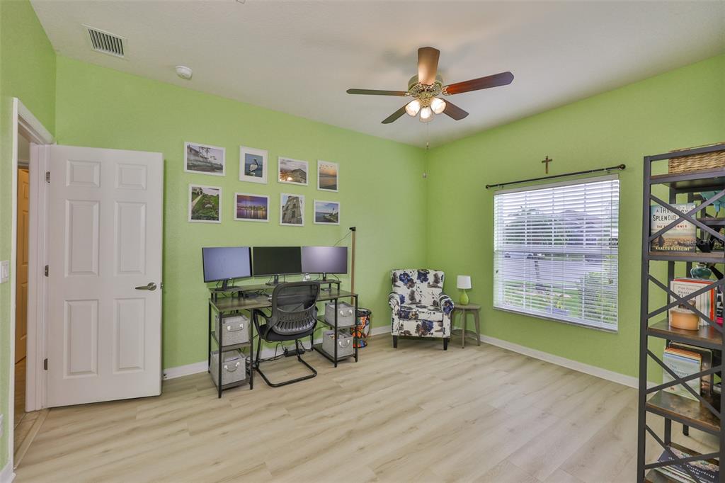 1516 Yale Castle Court Ruskin, FL 33570 - Photo 8 of 52 a workspace room with furniture and wooden floor