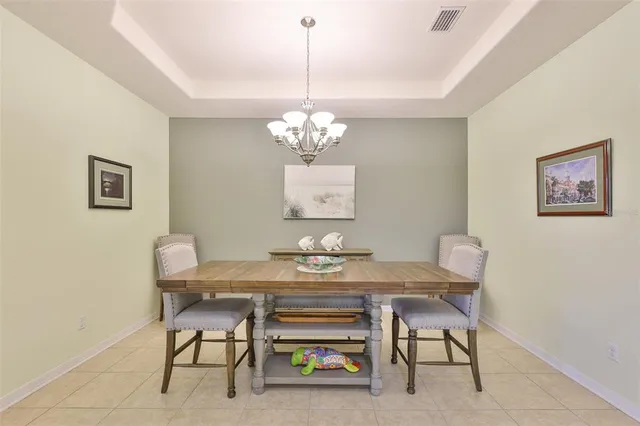 a view of a dining room with furniture and chandelier