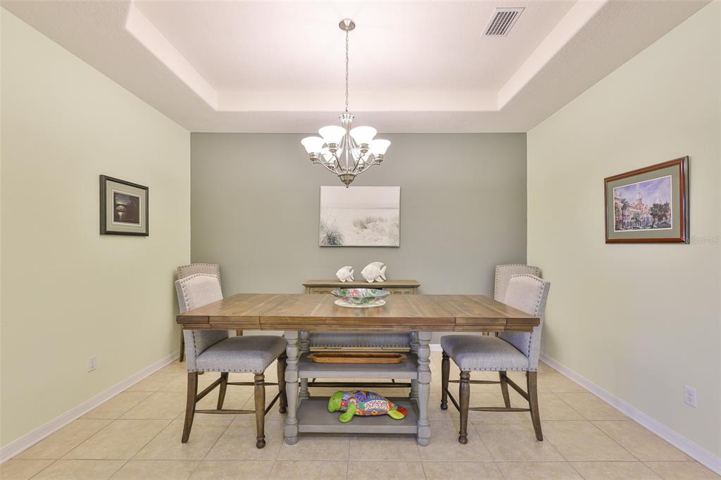 1516 Yale Castle Court Ruskin, FL 33570 - Photo 9 of 52 a view of a dining room with furniture and chandelier