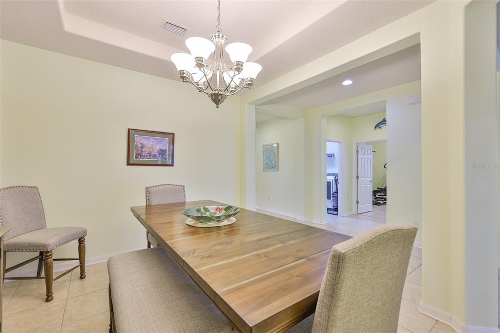 1516 Yale Castle Court Ruskin, FL 33570 - Photo 10 of 52 a view of a dining room with furniture and chandelier