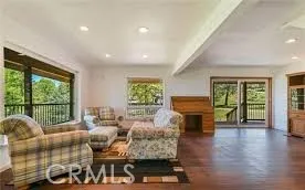 a living room with furniture and large windows