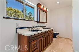 777 Morning Glory Road Mountain Ranch, CA 95246 - Photo 16 of 34 a bathroom with a sink and a mirror