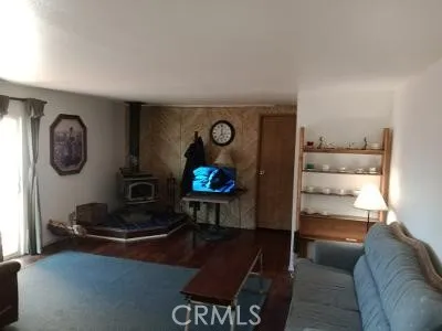 a living room with furniture a rug and a wall painting