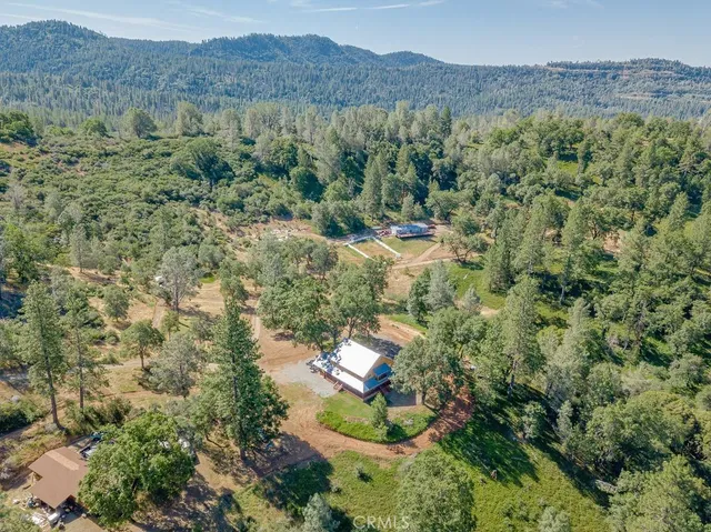 a view of a porch with wooden floor in front of a house