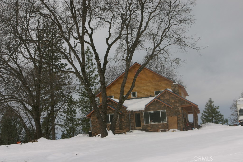 777 Morning Glory Road Mountain Ranch, CA 95246 - Photo 28 of 34 a view of a house with a yard covered in snow