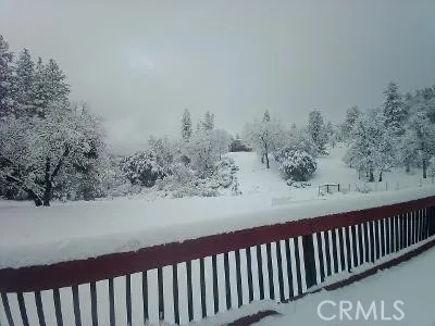 a view of a wooden fence and trees around