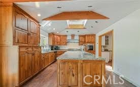 777 Morning Glory Road Mountain Ranch, CA 95246 - Photo 3 of 34 a view of a kitchen with kitchen island granite countertop wooden floor and stainless steel appliances
