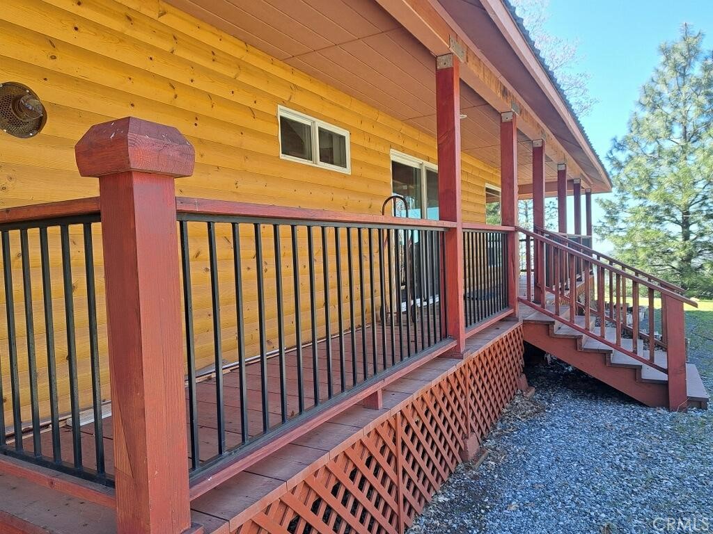777 Morning Glory Road Mountain Ranch, CA 95246 - Photo 31 of 34 a view of a brick house with wooden fence