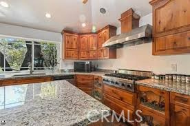 777 Morning Glory Road Mountain Ranch, CA 95246 - Photo 4 of 34 a kitchen with stainless steel appliances granite countertop a stove a sink and a white cabinets