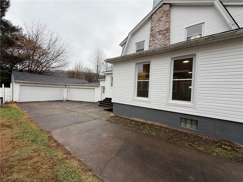 522 North 3rd Street Toronto, OH 43964 - Photo 2 of 47 View of home's exterior featuring a garage, an outdoor structure, and entry steps