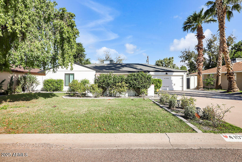 4102 East Pinchot Avenue Phoenix, AZ 85018 - Photo 1 of 28 a front view of a house with a yard and potted plants