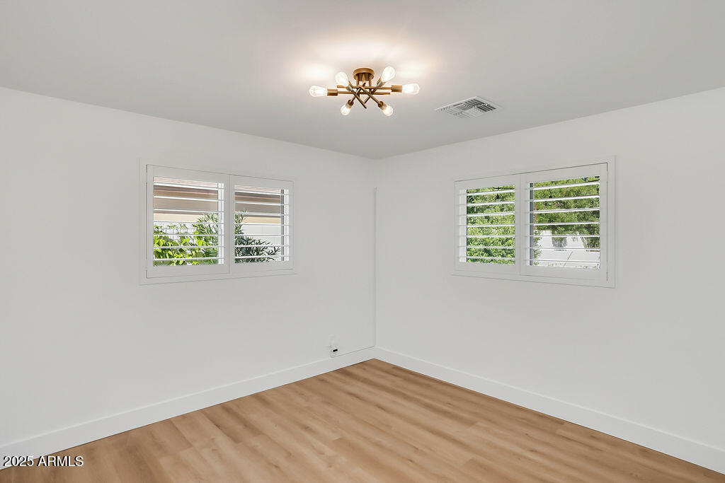 4102 East Pinchot Avenue Phoenix, AZ 85018 - Photo 17 of 28 an empty room with a window and a ceiling fan