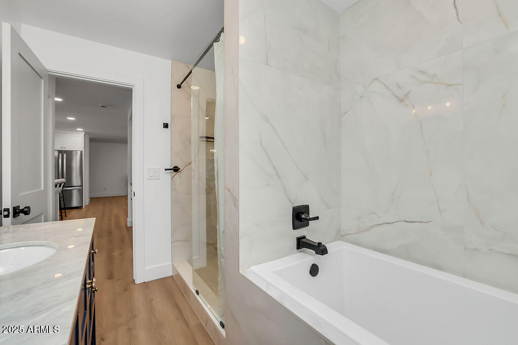 4102 East Pinchot Avenue Phoenix, AZ 85018 - Photo 20 of 28 a bathroom with a tub a sink and a large mirror