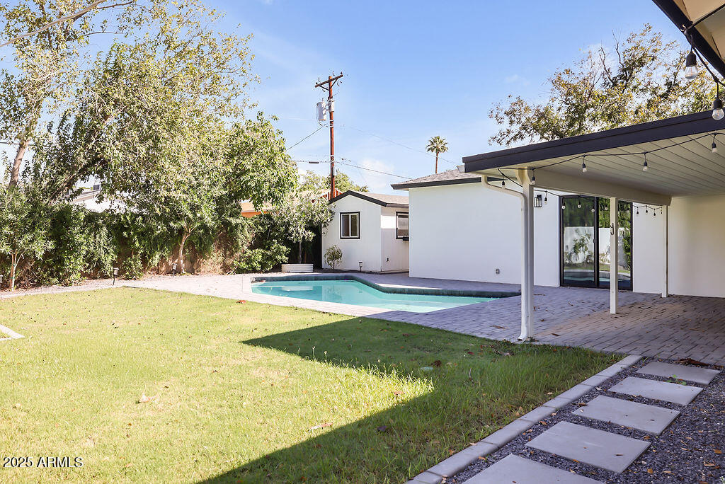 4102 East Pinchot Avenue Phoenix, AZ 85018 - Photo 23 of 28 a view of a house with swimming pool and sitting area