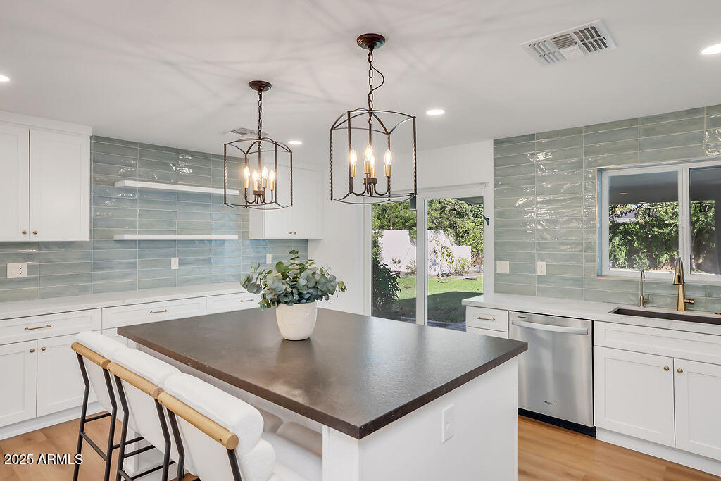 4102 East Pinchot Avenue Phoenix, AZ 85018 - Photo 6 of 28 a kitchen with a table and chairs in it