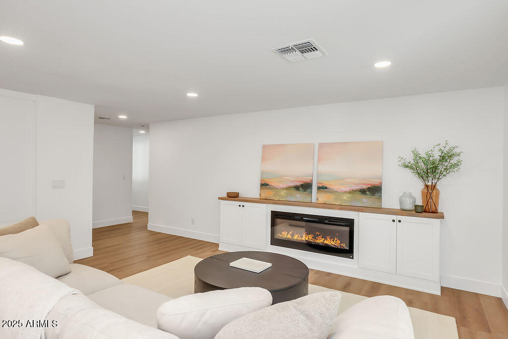 4102 East Pinchot Avenue Phoenix, AZ 85018 - Photo 7 of 28 a living room with furniture and a fireplace