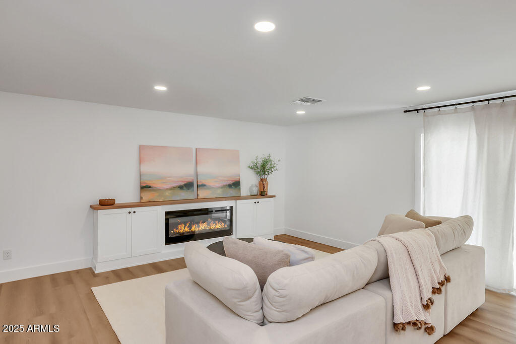 4102 East Pinchot Avenue Phoenix, AZ 85018 - Photo 8 of 28 a living room with furniture and a fireplace
