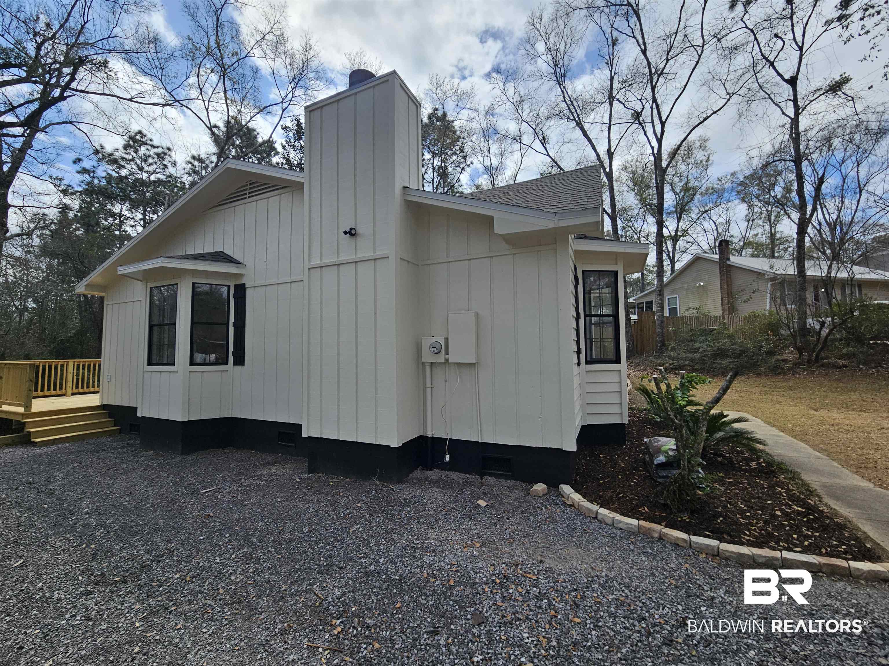 138 Wicker Way Daphne, AL 36526 - Photo 2 of 32 View of side of property featuring a chimney, crawl space, a wooden deck, and roof with shingles