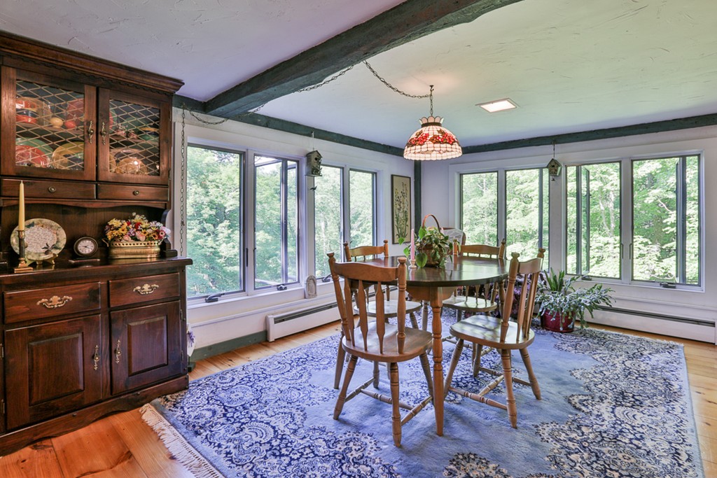 129 Gleason Road Princeton, MA 01541 - Photo 17 of 30 a view of a dining room with furniture wooden floor and a rug