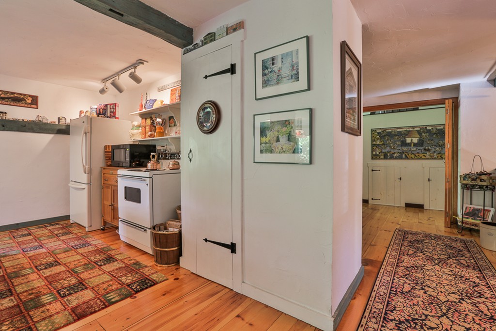 129 Gleason Road Princeton, MA 01541 - Photo 20 of 30 a view of a kitchen with fridge and wooden floor