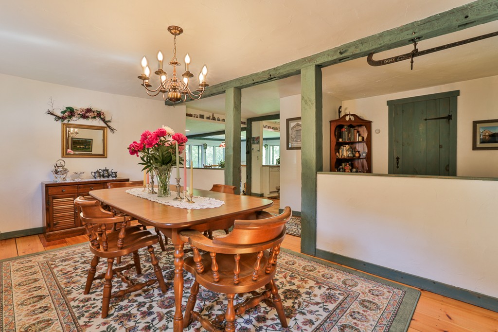 129 Gleason Road Princeton, MA 01541 - Photo 24 of 30 a dining room with chandelier and wooden floor
