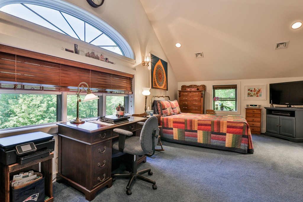 129 Gleason Road Princeton, MA 01541 - Photo 26 of 30 a bedroom with a bed a large window and a flat screen tv