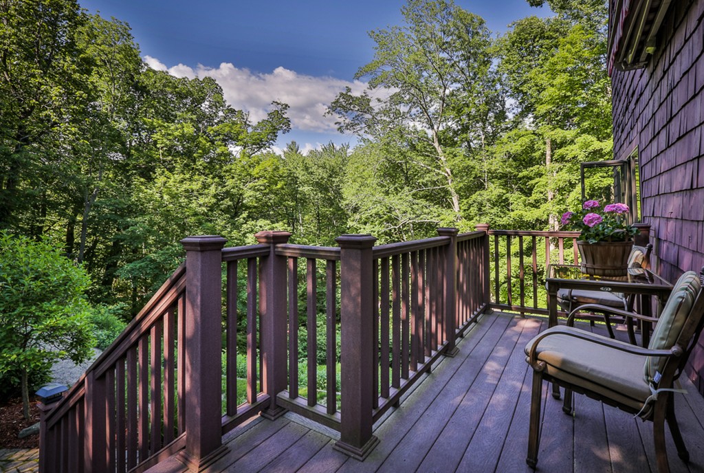 129 Gleason Road Princeton, MA 01541 - Photo 5 of 30 a balcony with wooden floor outdoor seating and yard in the back