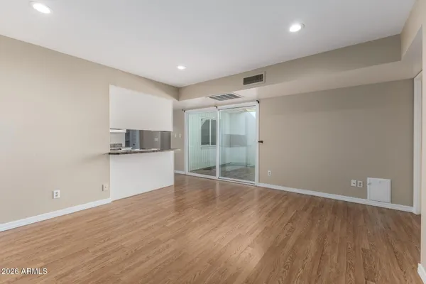 a view of a kitchen with a sink and wooden floor
