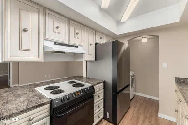 a kitchen with stainless steel appliances granite countertop a stove and a refrigerator