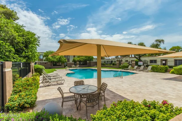 a view of a swimming pool and lounge chair