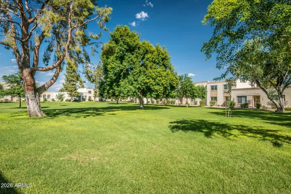 a front view of a building with palm trees