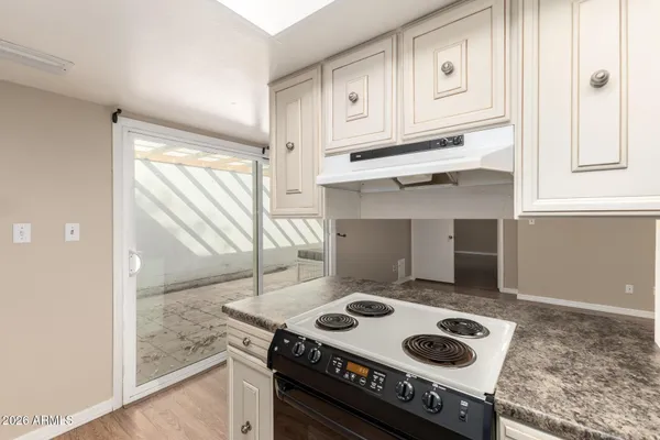 a kitchen with a stove and a refrigerator