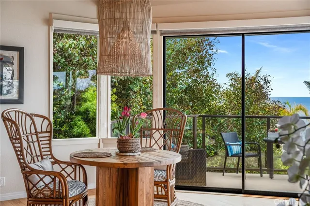 a view of a balcony with chairs and a potted plant