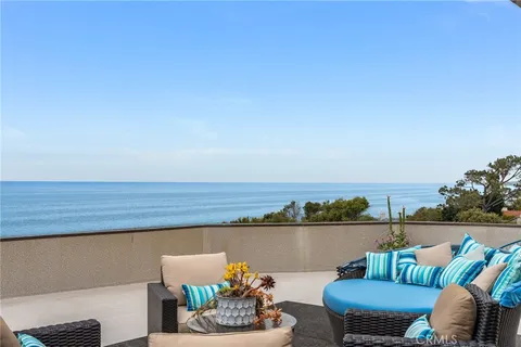 a terrace with outdoor seating and water view