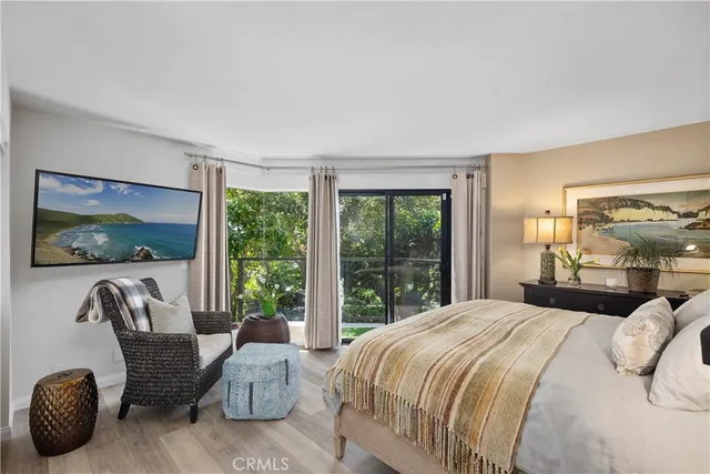 a bedroom with bed and a painting on the wall