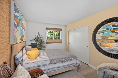 a bedroom with a bed and mirror with window