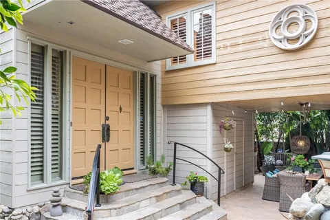 a view of a backyard with furniture and a garden