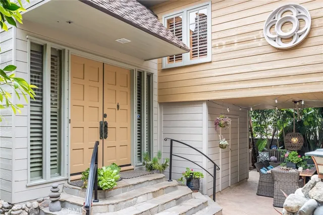 a view of a backyard with furniture and a garden