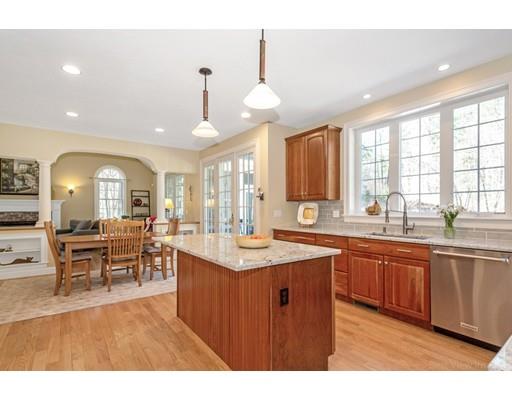 271 Sargent Road Boxborough, MA 01719 - Photo 7 of 29 a large kitchen with lots of counter top a sink dining table and chairs